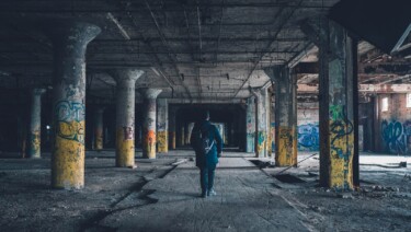 man walking hallway during daytime